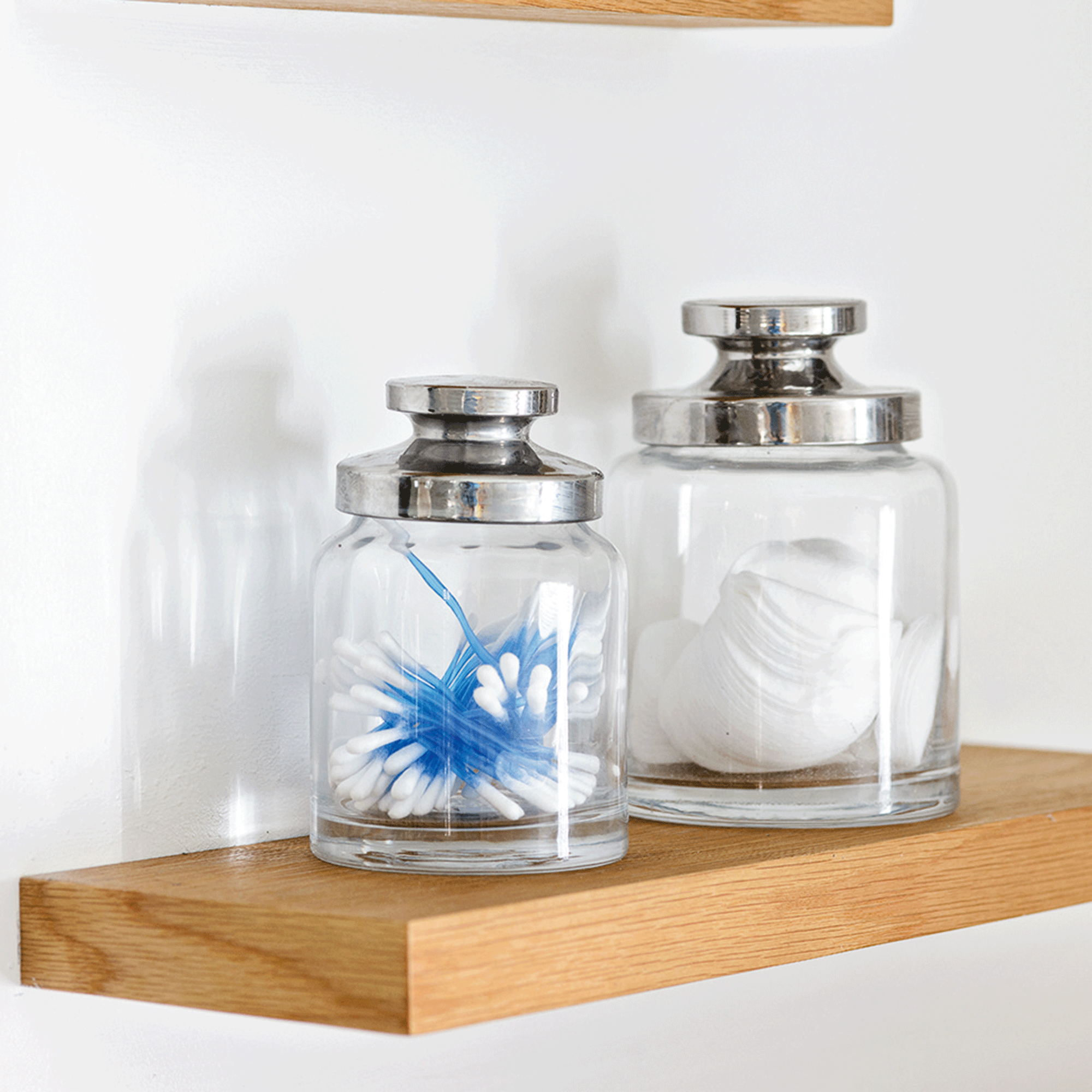Glass jars on bathroom shelf