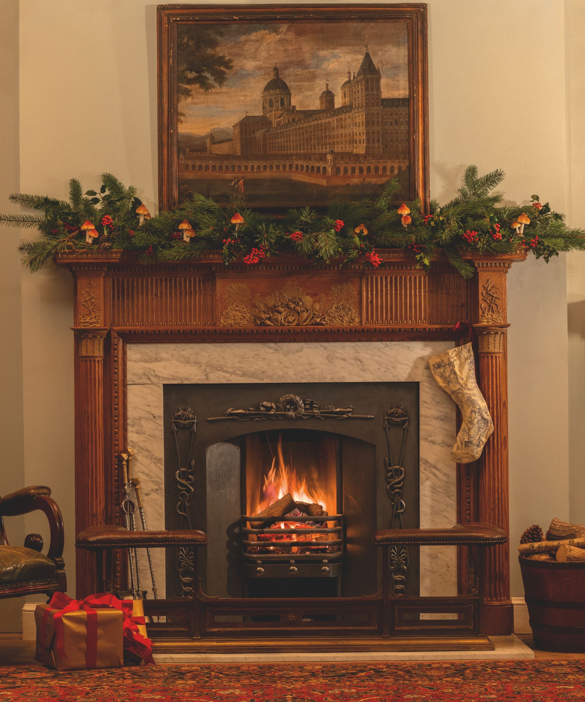 Fireplace with garland and antique landscape painting, presents and firetools