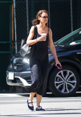 Katie Holmes walks in Lower Manhattan wearing a pair of Vibi Mary Janes with a black slip dress