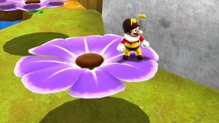 Super Mario Galaxy screenshot of Mario in his bee form, standing on a purple flower 