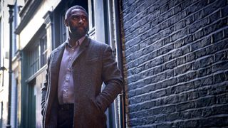 John Luther stands stoically in an alleyway in Luther: The Fallen Sun, one of the new Netflix movies to join our list