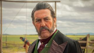 Richard M Watts (CIARÁN Hinds) in front of Eli Whipp in The English.