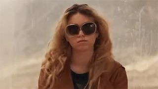 Milly Alcock's Kara Zor-El wearing a brown coat and sunglasses in 2026's Supergirl movie