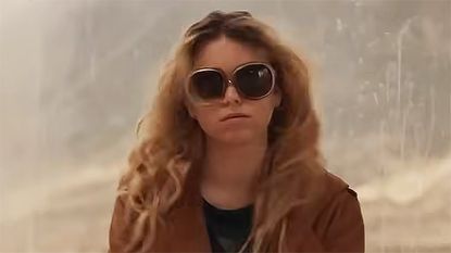 Milly Alcock's Kara Zor-El wearing a brown coat and sunglasses in 2026's Supergirl movie