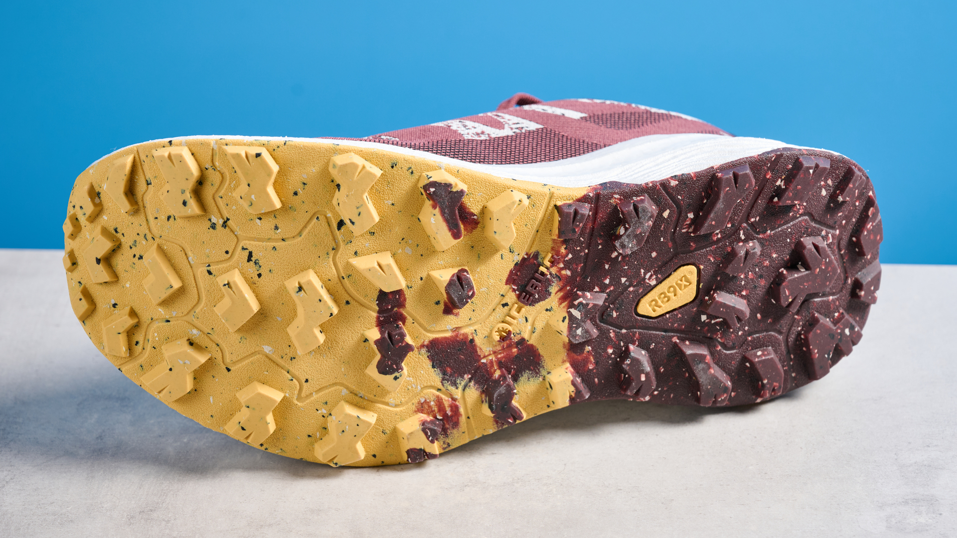 the icebug j&amp;auml;rv rb9x trail running shoes in cherry and banana photographed against the tom's guide blue background