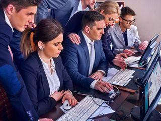 Business people in front of computers