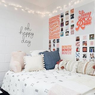 White room with gallery wall and string lights