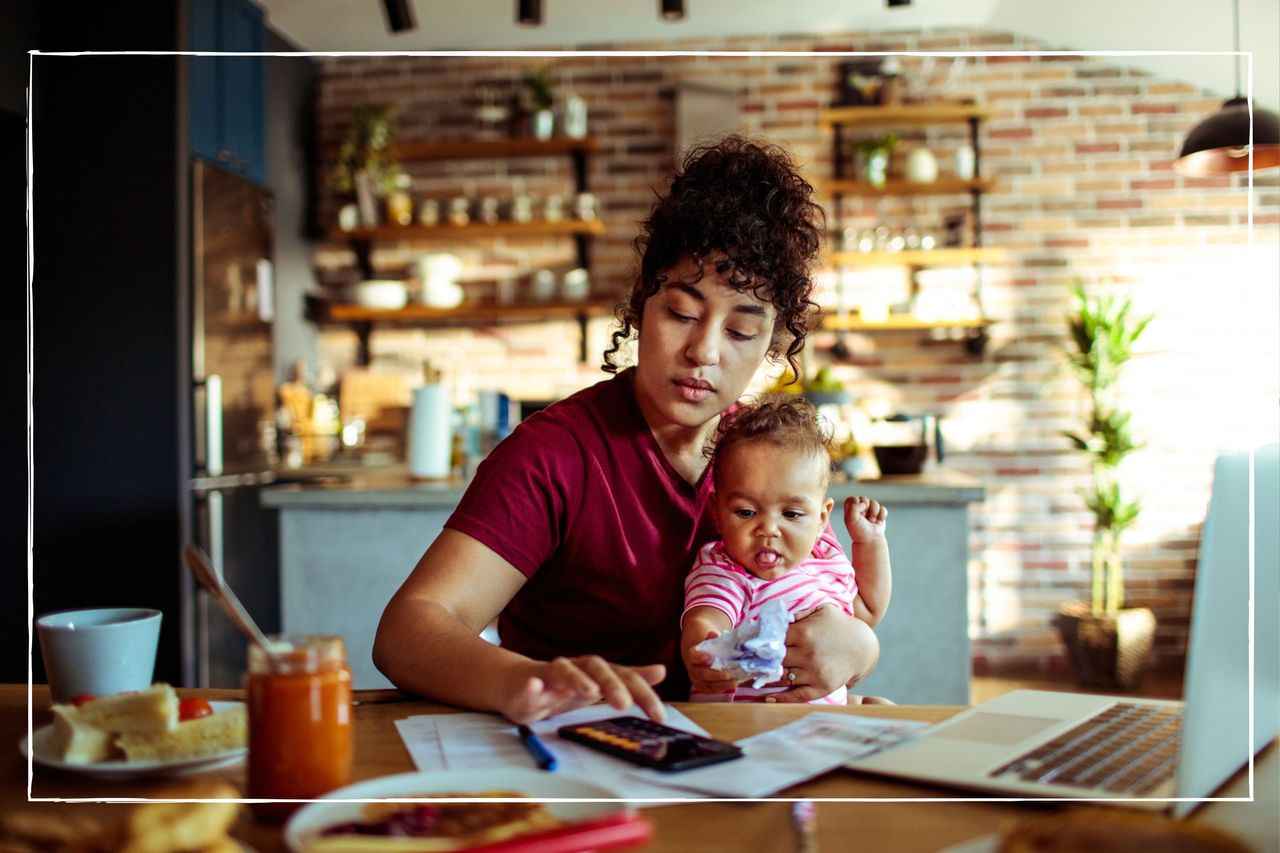 Mother using a phone with her daughter while having breakfast and calculating energy bills