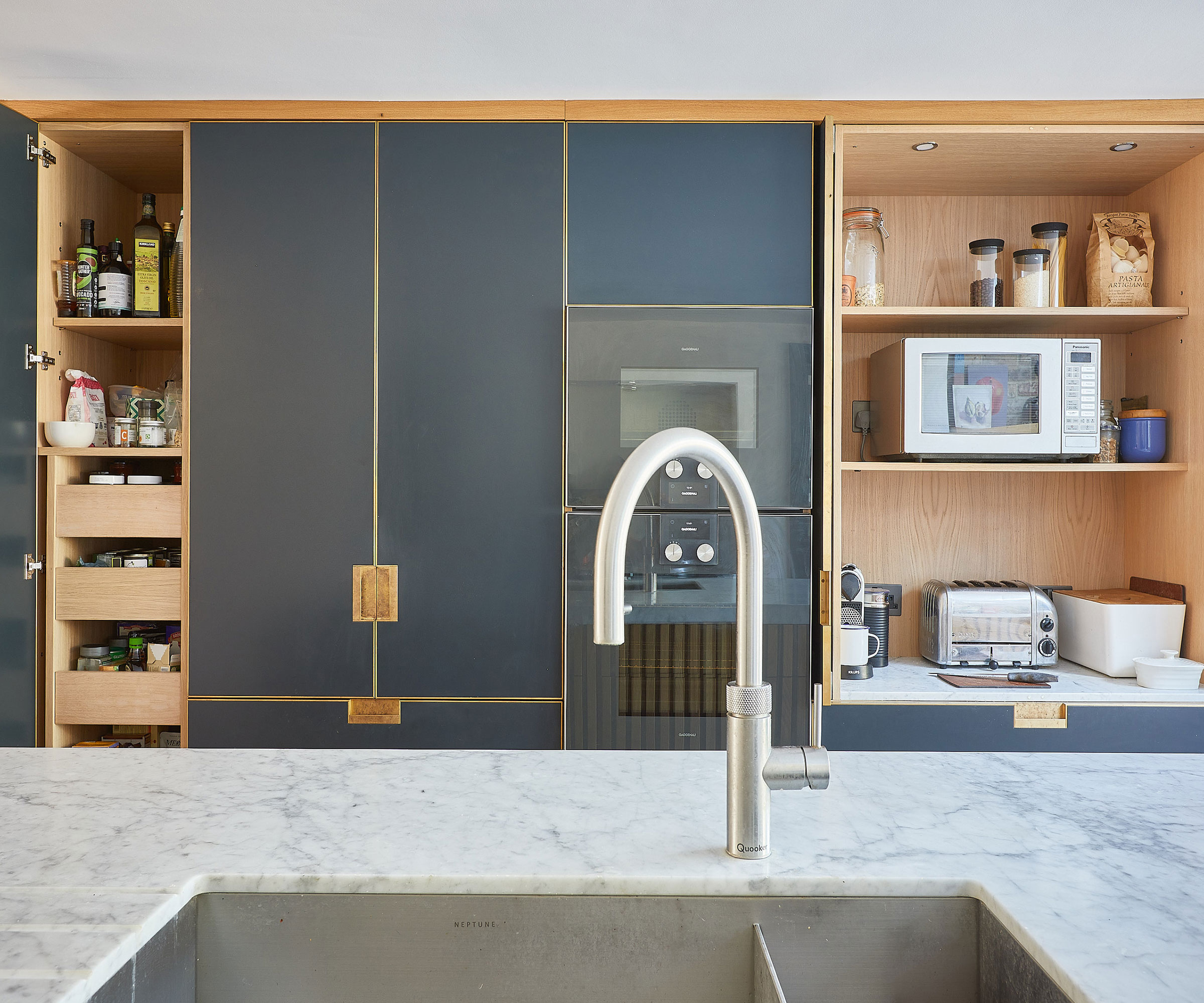 modern blue kitchen with appliance garage and marble composite worktop