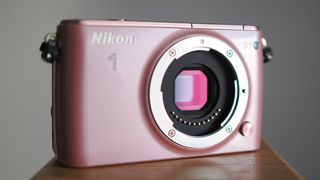 Pink Nikon 1 S1 with its image sensor exposed