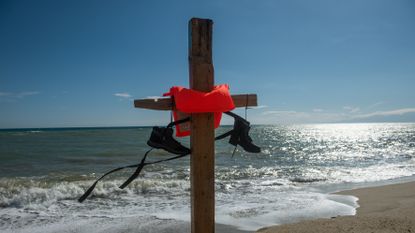 A homemade cross commemorates migrants lost at sea
