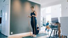 Woman exercising with resistance bands at home