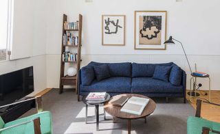 Living room with blue sofa and green armchairs