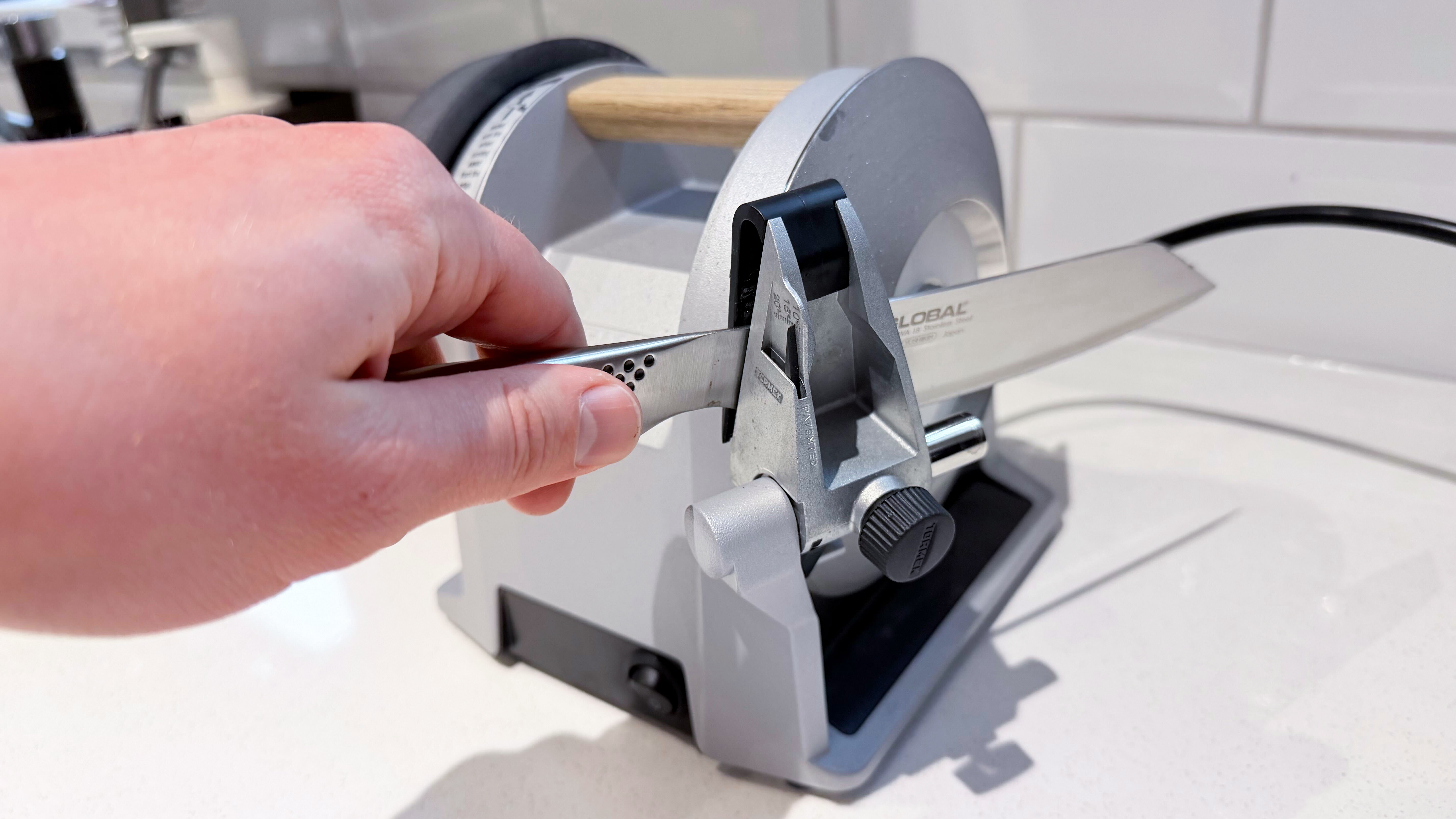 A knife being sharpened in the Tormek T-1 knife sharpener