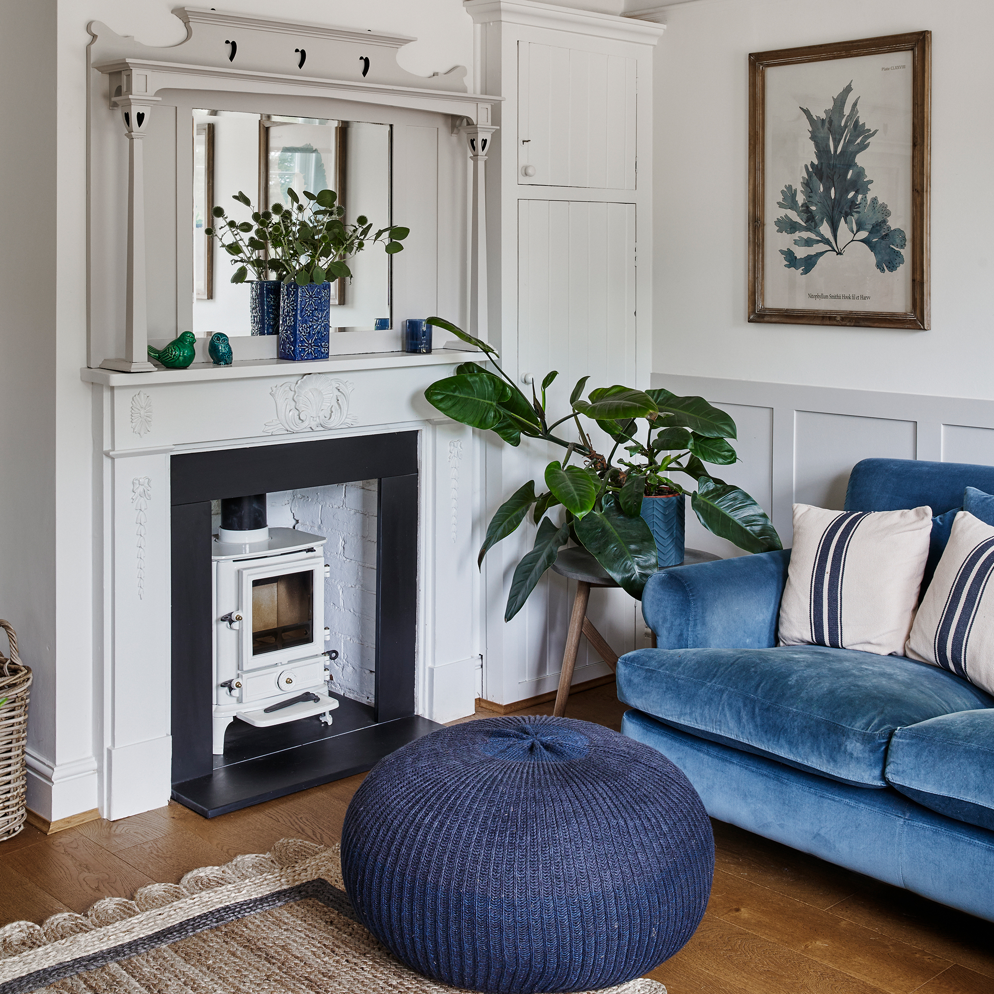 fireplace with white stove in a coastal style blue and white living room