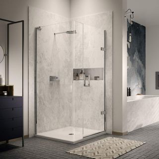 bathroom with white walls and dark mozaic floor tiles, matching white marble shower and separate bath, with a black watercolour wall behind the bath