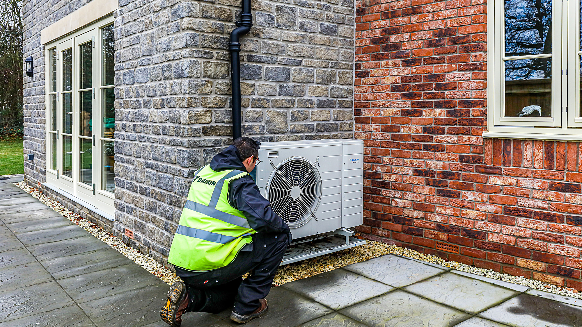 installing an air source heat pump on the exterior of a house