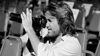 The Beach Boys’ Dennis Wilson holding a movie camera in 1977