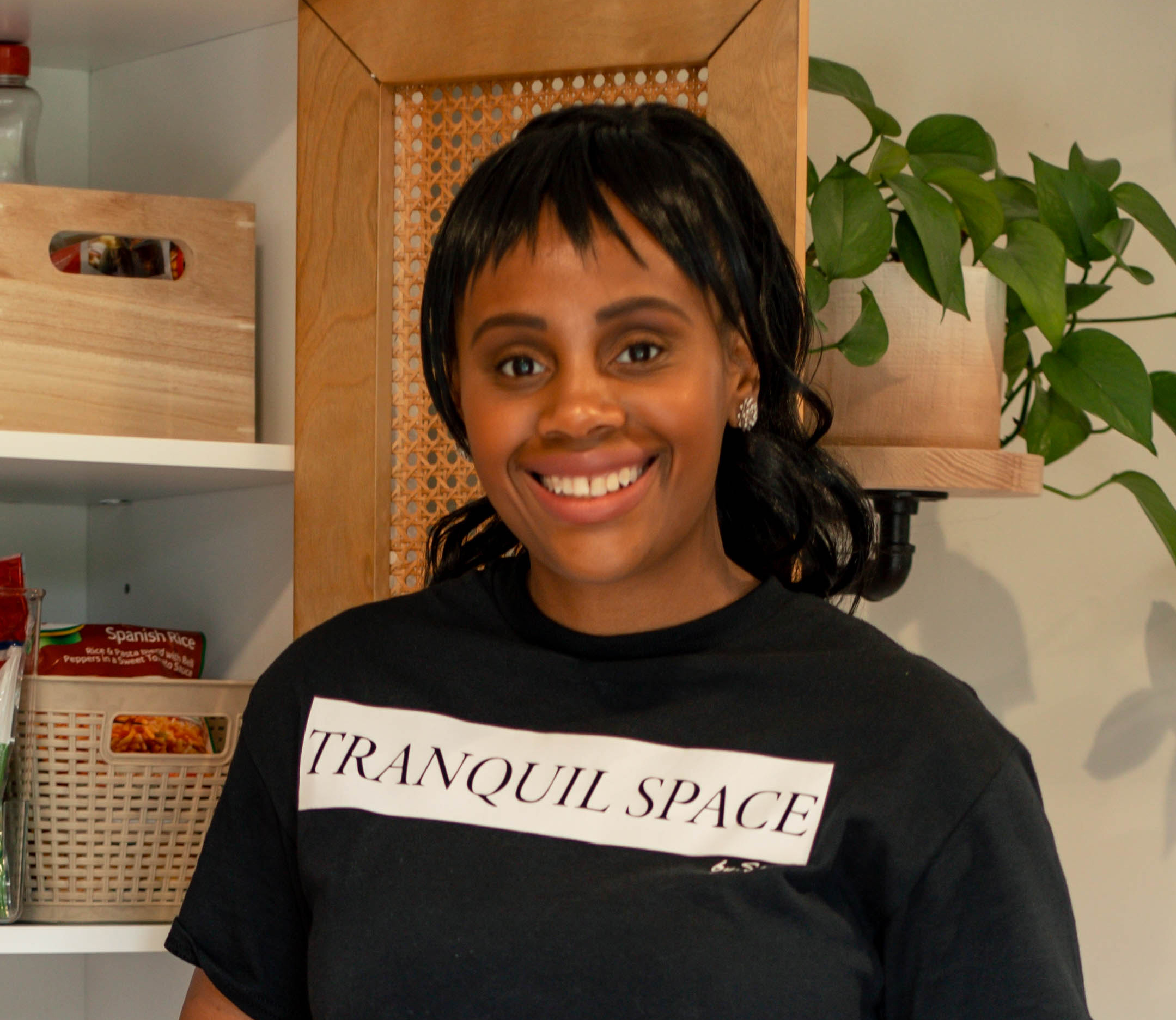 black woman in a black t-shirt that says 'tranquil space' on it