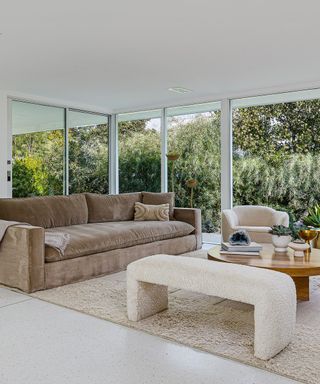 Mandy Moore sitting area with beige sofa, wood coffee table, and beige rug