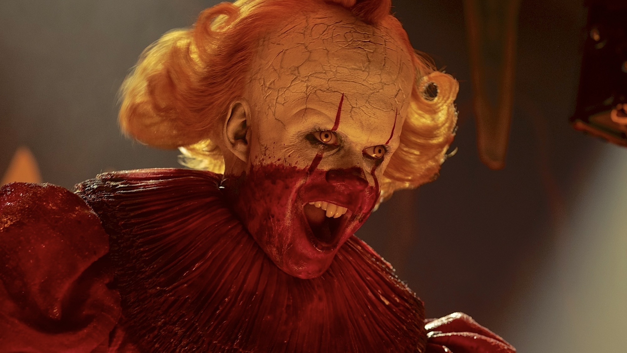 Pennywise with caping mouth and face half-covered with blood in IT: Welcome to Derry Season 1