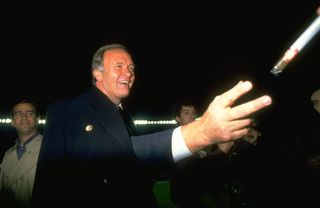 Ron Atkinson is handed a cigar after a game between Atletico Madrid and Real Madrid in 1989.