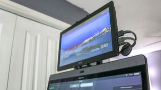 A picture of a Chromecast running on a portable monitor mounted above the Peloton Bike Plus