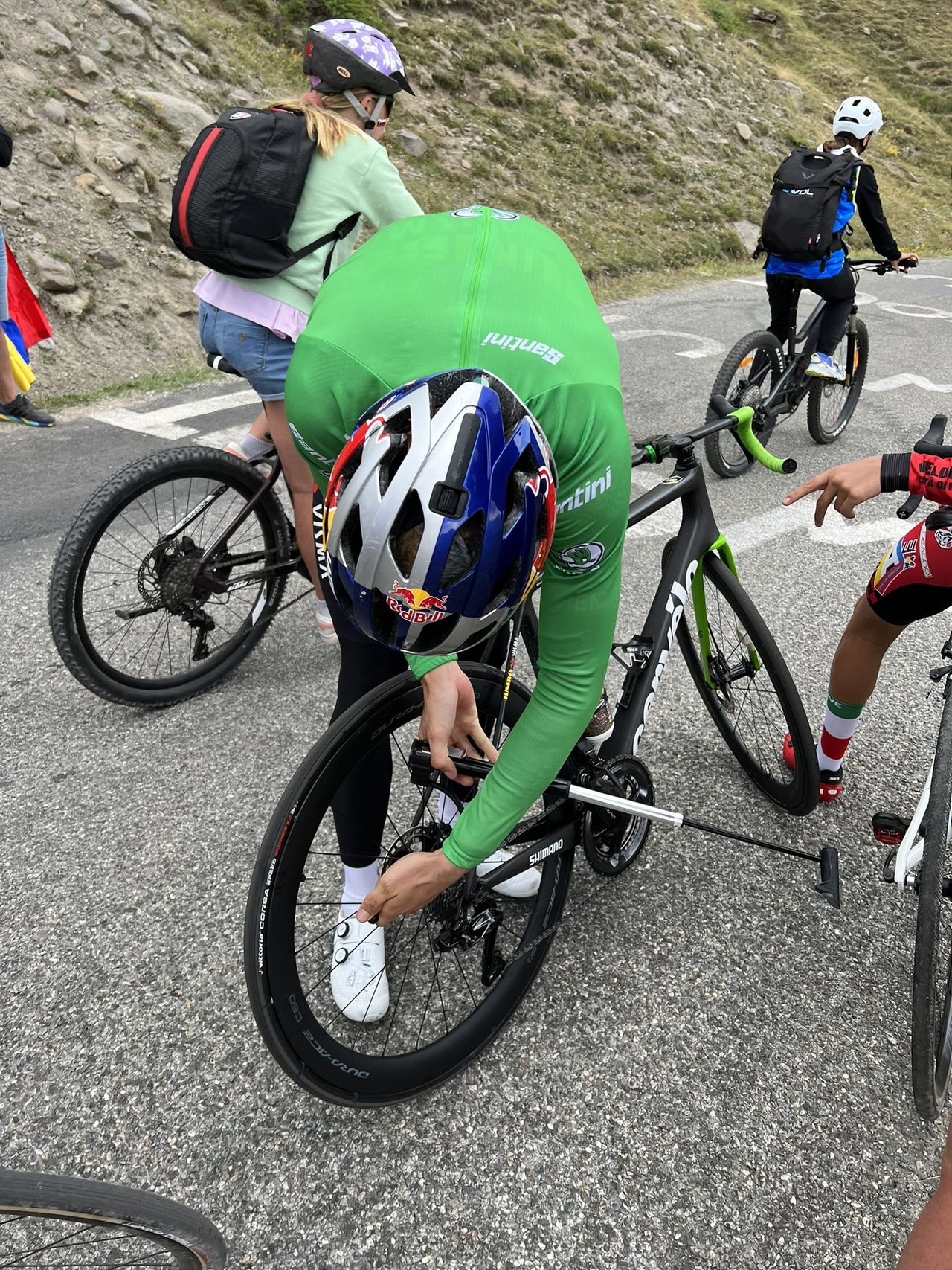 Wout van Aert (Jumbo-Visma) gets help fixing a flat tyre from some fans after stage 11 of the Tour de France