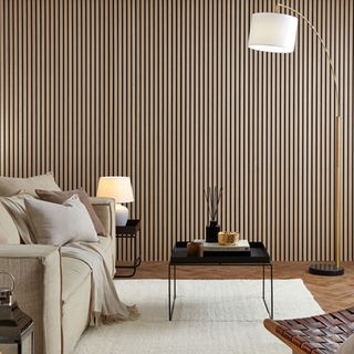 Living room with wooden wall panelling and white sofa