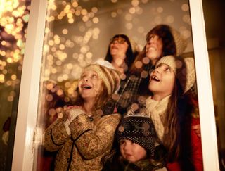 children watching fireworks with their mothers