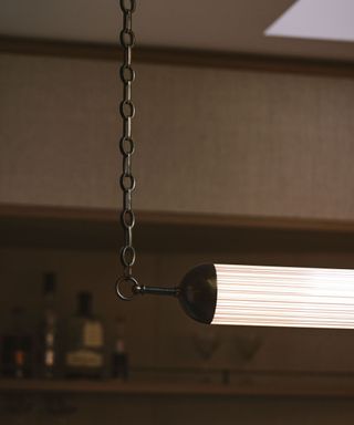 A closeup of a copper bar-style light fixture