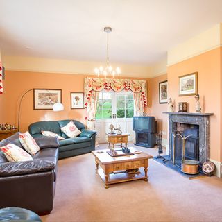 room with orange wall and sofa