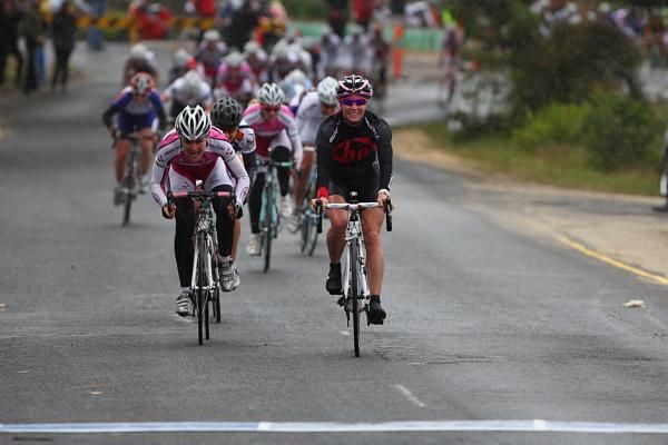Rochelle Gilmore (HP Pinarello) prepares to celebrate, whilst Kirsty Broun (MB Cycles) is still sprinting at the stage finish in Anglesea