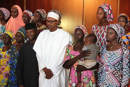 Nigerian President Muhammadu Buhari with 21 Chibok girls who were released by Boko Haram
