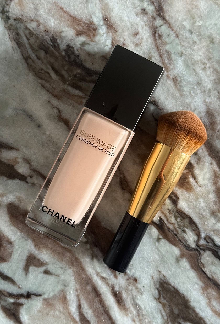 Chanel sublimage foundation and brush on a marble surface
