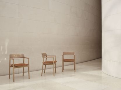 Three chairs by Foster and Partners and Benchmark, photographed to show three different angles and featuring brown leather seats