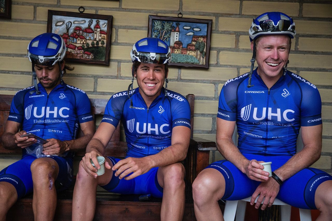 Lachlan Norris, Daniel Eaton, and Tanner Putt (l-r) have a quick cup of coffee before a training ride, sporting the all-new Jakroo custom kits