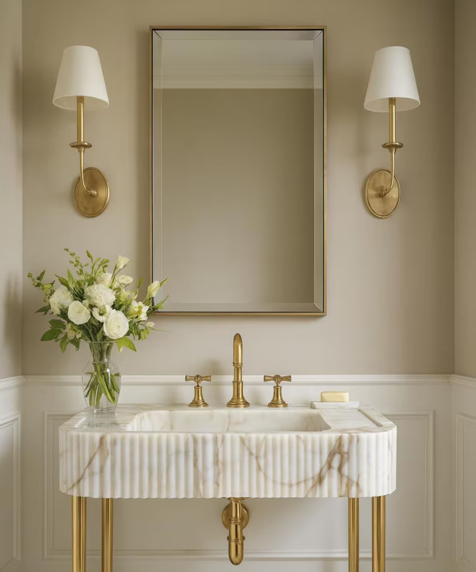 A warm neutral bathroom with a fluted marble vanity