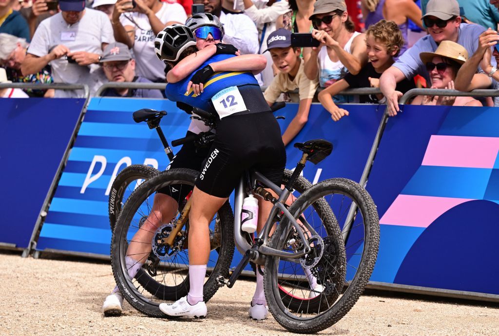 American Haley Batten and Swedish Jenny Rissveds celebrate after the women's cross-country cycling race of the Paris 2024 Olympic Games, at the Colline d'Elancourt climb near Paris, France on Sunday 28 July 2024. The Games of the XXXIII Olympiad are taking place in Paris from 26 July to 11 August. The Belgian delegation counts 165 athletes competing in 21 sports. BELGA PHOTO LAURIE DIEFFEMBACQ (Photo by LAURIE DIEFFEMBACQ / BELGA MAG / Belga via AFP)