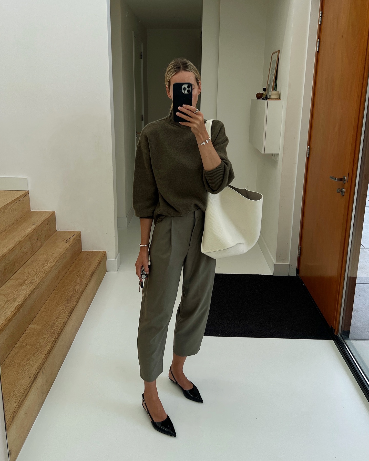 @anoukyve wears cropped tailored trousers with a green jumper