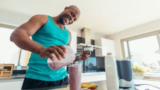 Protein powder side effects: Image shows man making protein shake