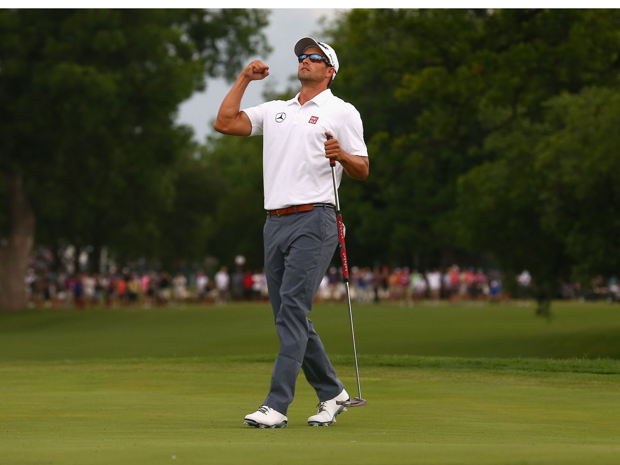 Adam Scott celebrates a birdie putt on the third playoff hole to defeat Jason Dufne in the 2014 Crowne Plaza Invitational