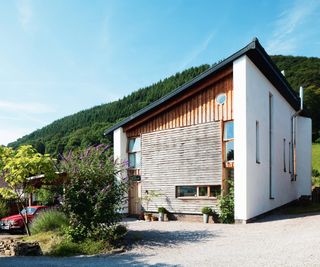 white contemporary house with timber cladding on one side