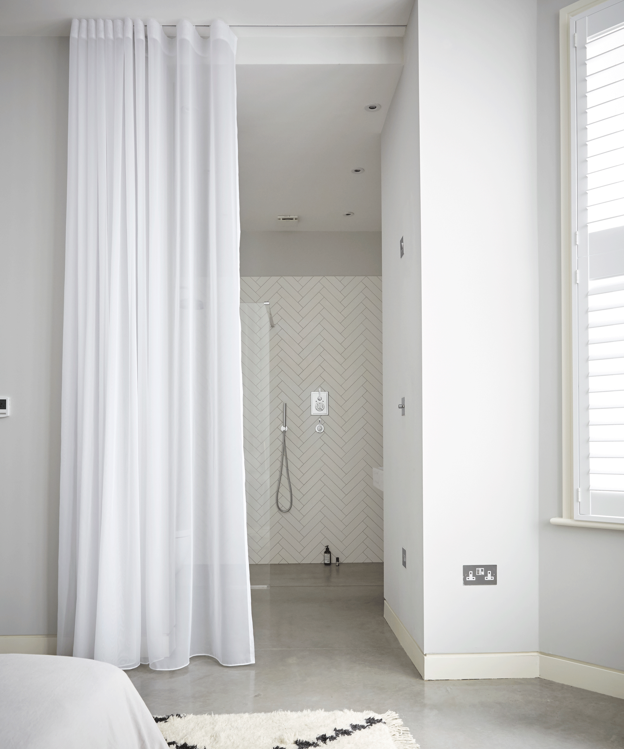 White shower curtain in white bathroom