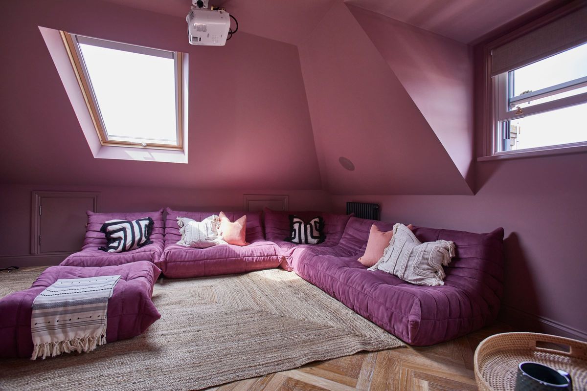 A pink corner sits in the loft conversion with two dormer windows protruding above