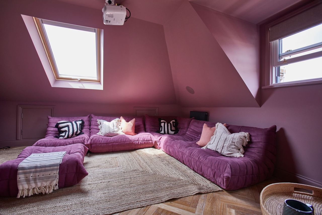 A pink corner sits in the loft conversion with two dormer windows protruding above