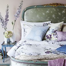 bedroom with floral printed bedding set and bed with pillows