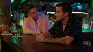Billy Magnussen looks at Jake Gyllenhaal with a face of determined anger in Road House.