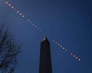 A composite image of a partial eclipse on April 8 as seen above the Washingotn Monument