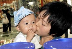Marie Claire World News: Woman with baby - China milk scandal